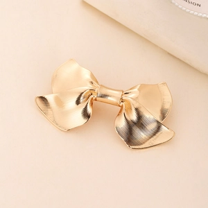 Elegant gold metal bow hair clip with vintage pleated texture for a sophisticated look