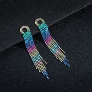Macro shot of long rainbow tassel earrings with multi-color rhinestones on black background