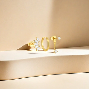 Detailed close-up of gold-plated S925 silver earring set with sparkling zircon stones