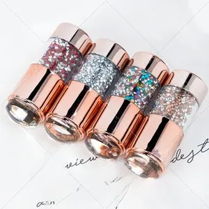 Detailed view of four colors nail art glitter sequins in rose gold luxury containers