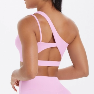 Pink sports bra featuring unique asymmetrical back straps and modern cutout design