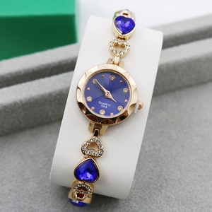 Women's gold quartz bracelet watch with blue dial and rhinestone heart-shaped links