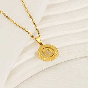18K gold plated stainless steel necklace with round hollow letter D pendant on white background