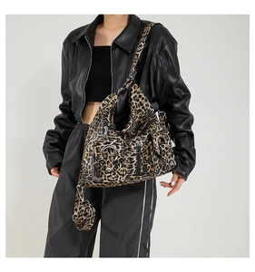 Leopard print tote bag detail showing metal buckles and multi-pocket design for women