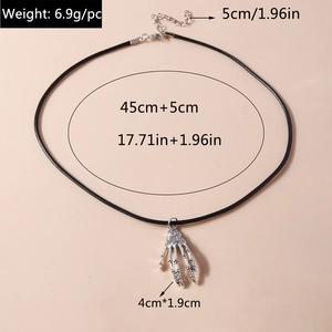 Macro view of skeleton hand necklace with detailed size and weight specifications