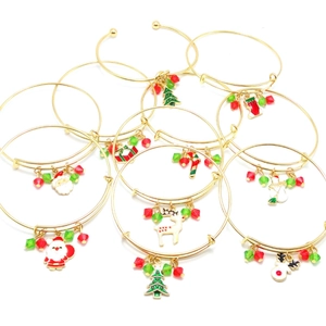 Adjustable golden Christmas bangle with enamel charms like Santa and reindeer charms