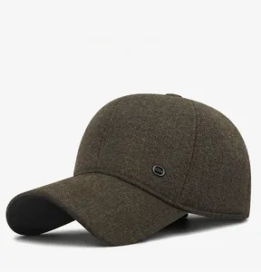 Detail of dark brown wool baseball cap with ear protection and Fashion metal badge