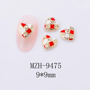 Macro shot of 9x9mm checkered heart nail charms with red, white and gold enamel texture
