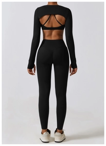 Back view of black long-sleeved cutout yoga top and high-waisted fitness leggings