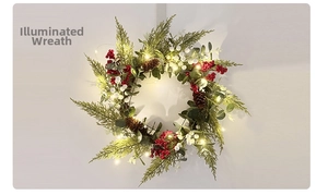 Close-up of Christmas wreath with warm LED lights, pine cones, and red berries on a wall