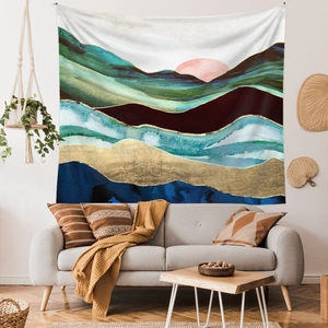 Modern abstract landscape tapestry with navy and gold mountain pattern in a stylish living room