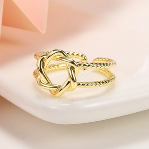 Detailed close-up of 18k gold plated braided ring with intricate twisted knot design