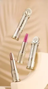Detailed macro view of dual-color eyeshadow stick with golden opera mask design