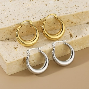 Minimalist chunky oval gold and silver stainless steel hoop earrings on stone base