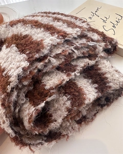 Detailed macro view of soft brown and beige checkerboard mohair wool knit fabric texture