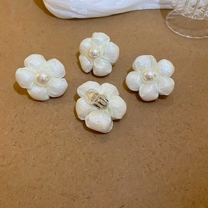 Elegant white camellia flower stud earrings with faux pearl and shimmering texture