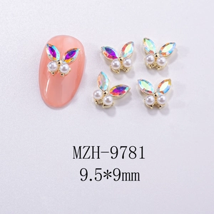 Macro view of butterfly nail charms with aurora rhinestones and pearls measuring 9.5*9mm
