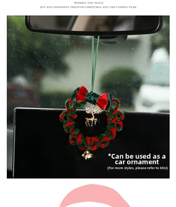 Close-up of a handmade plush Christmas wreath car pendant with reindeer and gold bell