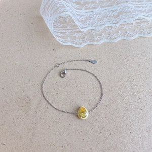 Detail of S925 sterling silver chain with yellow pear-cut gemstone and enamel finish