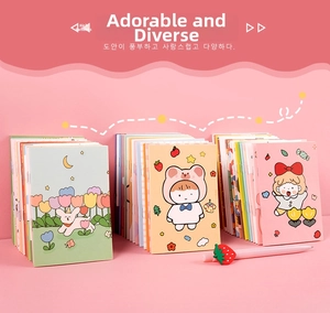 Detail of cute cartoon notebooks with various illustrated covers and strawberry pen