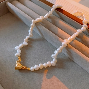 Detailed close-up of Baroque freshwater pearl necklace with golden heart magnetic clasp
