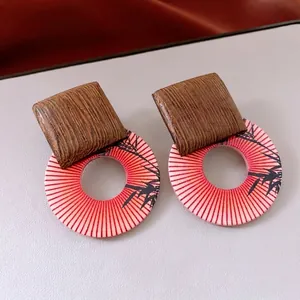 Vintage round wooden earrings with silver needles and ethnic print in luxury style