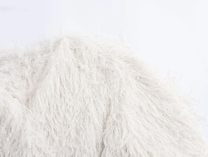 Détail macro de fausse fourrure blanche douce montrant des fibres pelucheuses denses