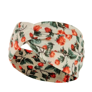 Detailed view of bohemian fabric headband with red rose pattern and cross-knot design