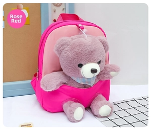 Detail of rose red kids backpack featuring a cute plush bear with a blue floral scarf