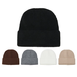 Flat lay of multi-color winter knitted beanies featuring thick ribbed texture and wide cuffs