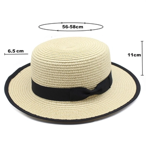 Detail of straw sun hat with black ribbon edge showing 56-58cm size and 6.5cm brim