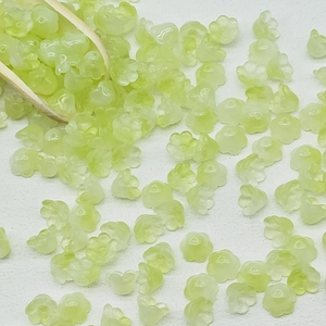 Macro detail of 7x12mm light green translucent lily of the valley glass flower beads