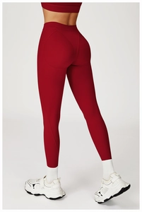 Detail of high waist dark red yoga leggings with peach-lift stitching and matte fabric
