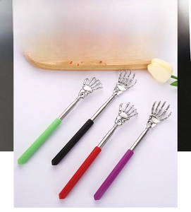 Detailed view of four colorful telescopic back scratchers with skull hand design features