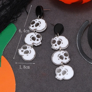 Detail view of white acrylic skeleton drop earrings showing 6.4cm length and tiered design
