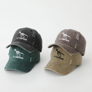 Close-up of dinosaur skeleton embroidery and distressed holes on washed canvas caps