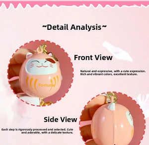 Detail view of pink Maneki Neko charm with golden Fu character and metal hook