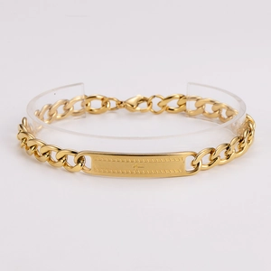 Detailed view of a gold-plated stainless steel Cuban link bracelet with cross engraved ID tag
