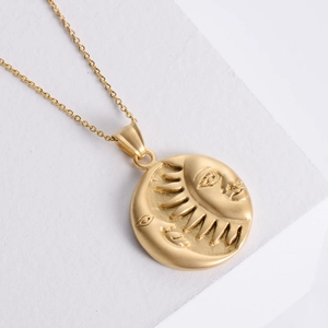 Vintage 18K gold plated celestial necklace with embossed sun and moon pendant on stone