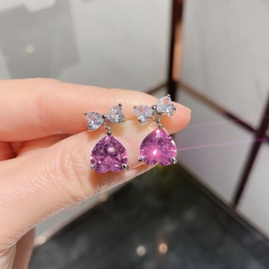 Pink heart crystal earrings with bow design in polished silver-tone claw setting