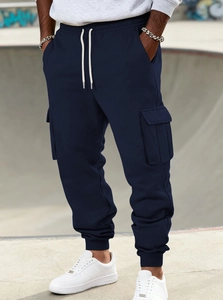 Detailed view of navy blue cargo pants with drawstring waist and large side pockets