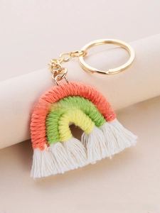 Macro shot of handmade woven rainbow keychain with colorful cotton ropes and white tassels