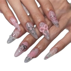 Y2K style press-on nails with 3D pink bows, pearls, and silver stars in almond shape