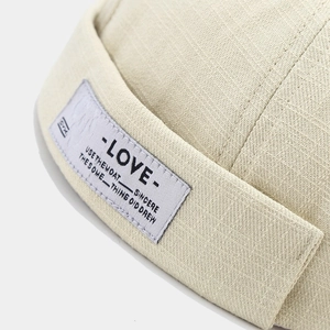 Macro shot of beige docker hat fabric texture with LOVE letter patch detail