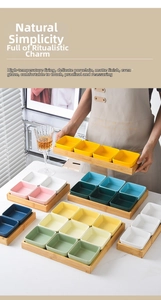 Detailed view of matte ceramic appetizer dishes in various colors with a wooden tray