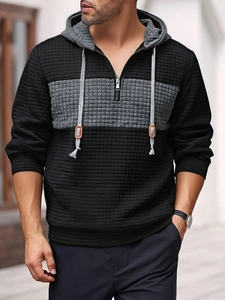 Macro shot of men's waffle texture hoodie with grey paneling and leather drawstring detail