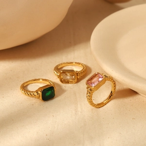 Elegant gold titanium steel rings with rectangular green, yellow, and pink gemstones