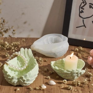 DIY angel wing silicone mold for resin jewelry trays and candle holders on wooden table