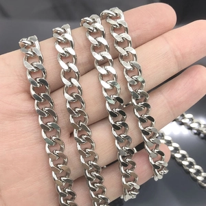 Silver stainless steel Cuban link necklace held in hand showing size and thick chain texture