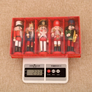 Five-piece wooden nutcracker ornament set in a red star gift box weighed on a scale